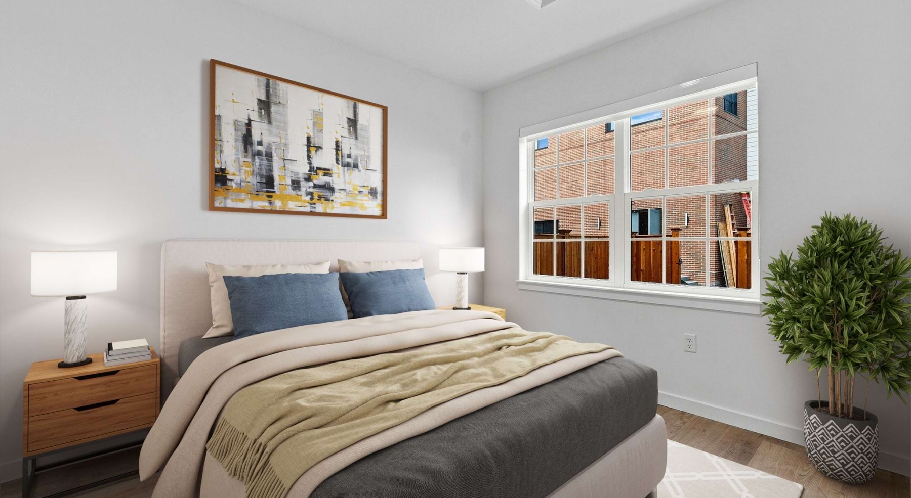 bedroom with bed tables lamps windows and plant