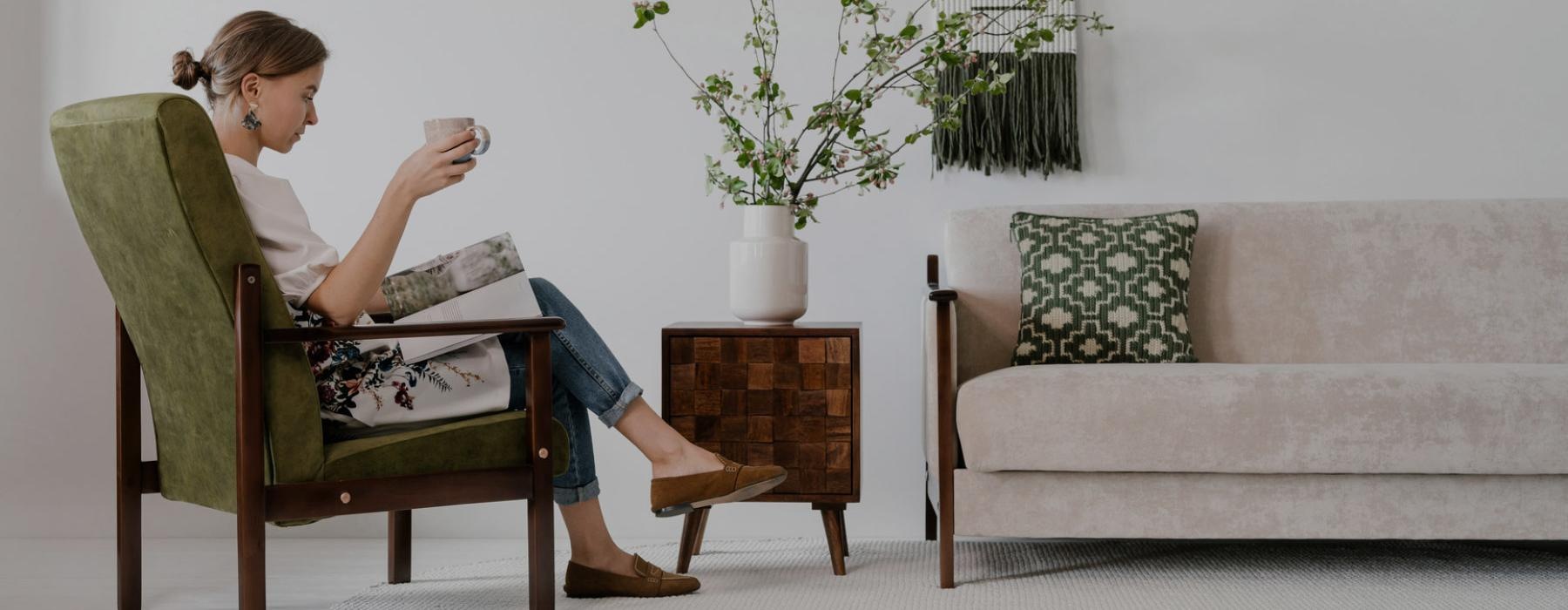 a person sitting in a chair reading a book