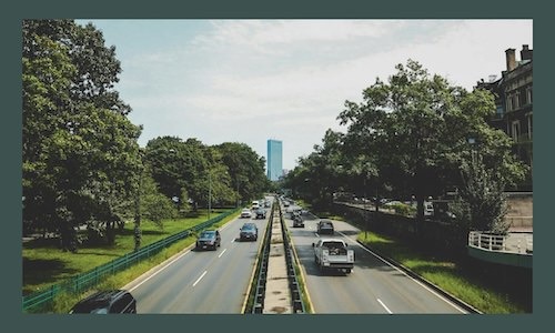 cars driving down a street