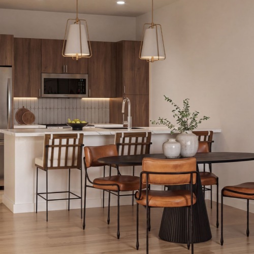 a kitchen and dining room area with a table and chairs