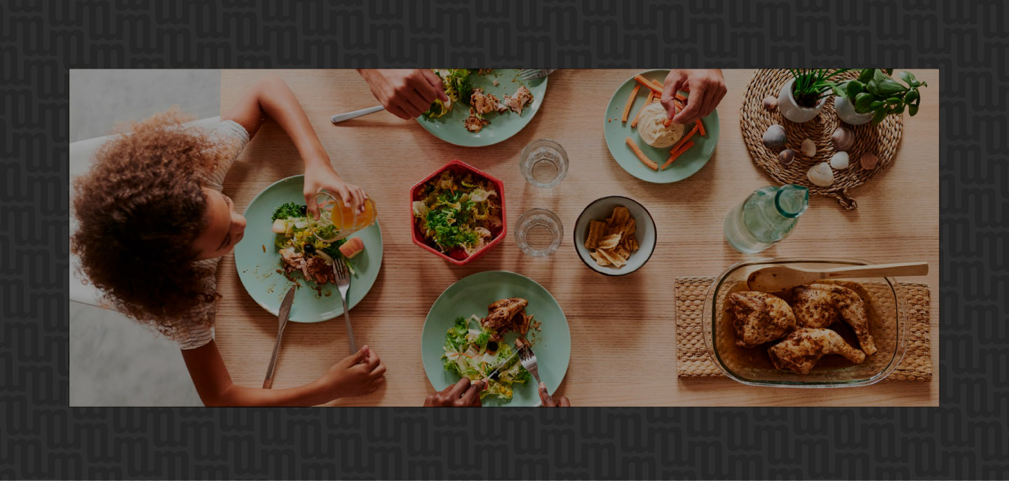 someone sitting at a dinner table with lots of food